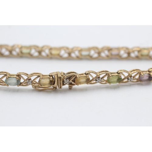 1014 - A 9ct yellow and white gold diamond, topaz, citrine and peridot fancy chain bracelet - approx. gross... 