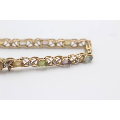 1014 - A 9ct yellow and white gold diamond, topaz, citrine and peridot fancy chain bracelet - approx. gross... 