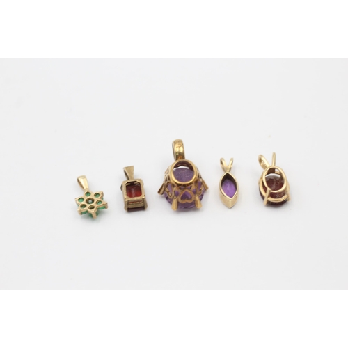 1026 - Five 9ct gold gemstone set pendants, one amethyst, one diamond and amethyst, two garnet and one emer... 