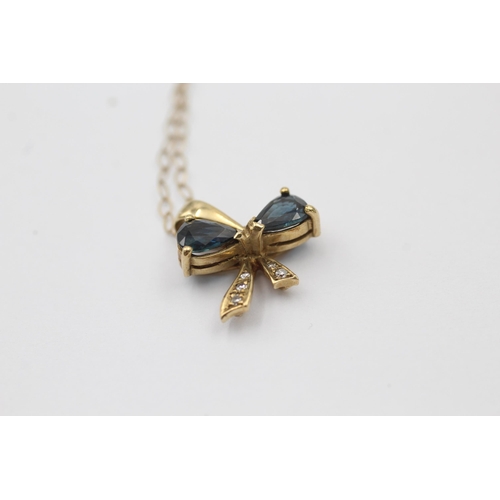 1033 - A 9ct gold diamond and sapphire bow pendant necklace - approx. gross weight 1.5 grams