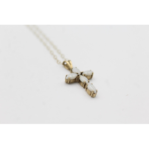 1034 - A 9ct gold opal cross pendant necklace - approx. gross weight 1.4 grams and 20.5cm long when fastene... 