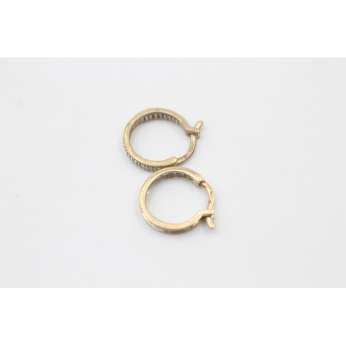 1036 - A pair of 9ct yellow and white gold diamond hoop earrings - approx. gross weight 2 grams