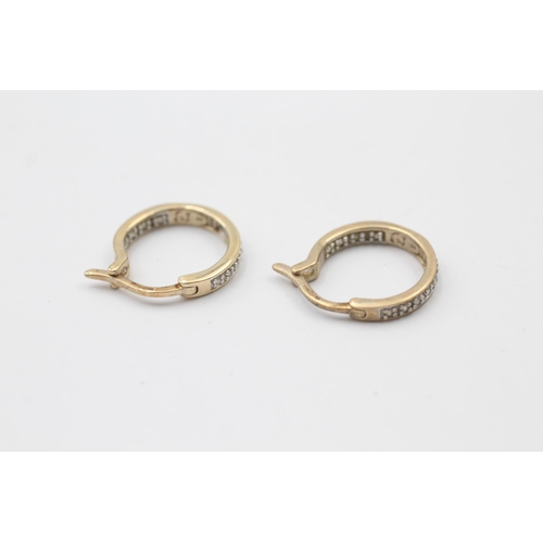 1036 - A pair of 9ct yellow and white gold diamond hoop earrings - approx. gross weight 2 grams