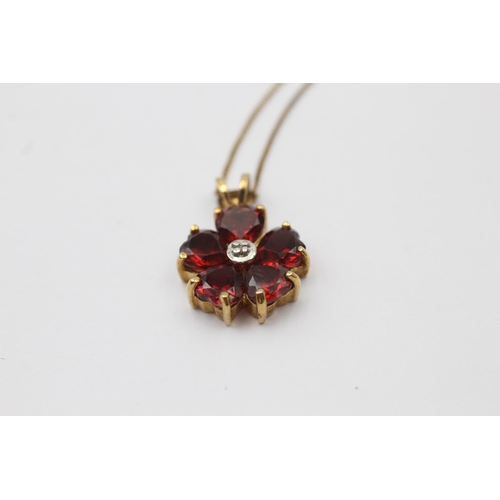 1046 - A 9ct gold diamond and garnet floral pendant necklace - approx. gross weight 2.2 grams