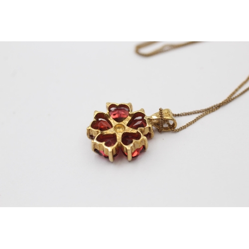 1046 - A 9ct gold diamond and garnet floral pendant necklace - approx. gross weight 2.2 grams