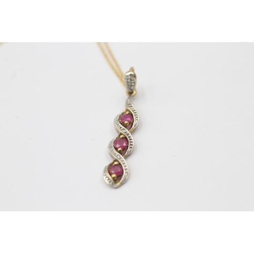 1048 - A 9ct gold diamond and ruby pendant necklace - approx. gross weight 1.8 grams