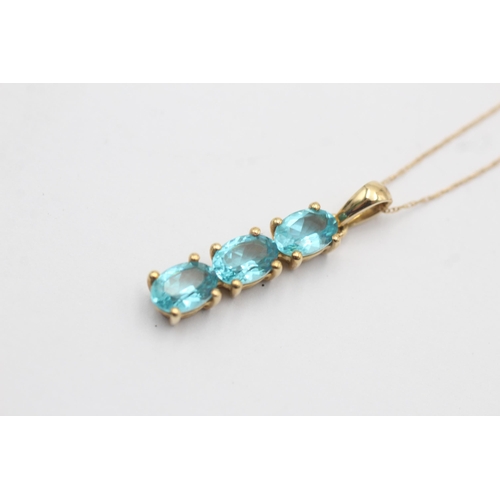 1051 - A TGGC 9ct gold blue gemstone pendant necklace - approx. gross weight 2.3 grams