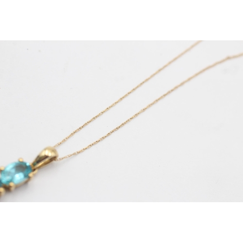 1051 - A TGGC 9ct gold blue gemstone pendant necklace - approx. gross weight 2.3 grams