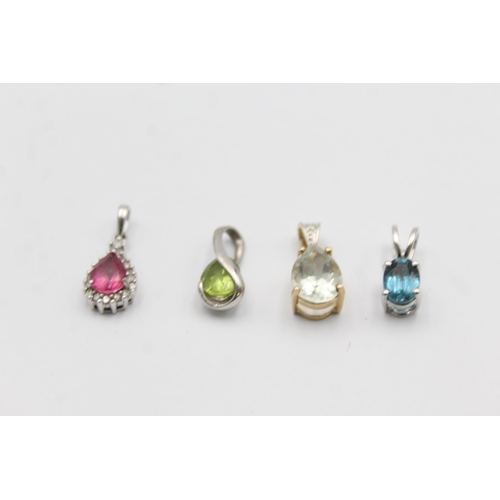 1057 - Four 9ct yellow and white gold gemstone set pendants, one peridot, one topaz, one coated pink topaz ... 