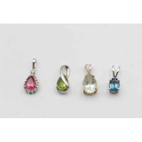 1057 - Four 9ct yellow and white gold gemstone set pendants, one peridot, one topaz, one coated pink topaz ... 