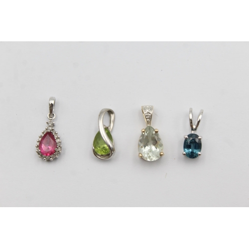 1057 - Four 9ct yellow and white gold gemstone set pendants, one peridot, one topaz, one coated pink topaz ... 