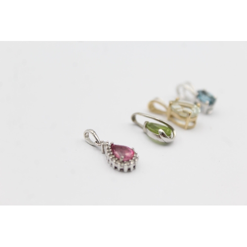 1057 - Four 9ct yellow and white gold gemstone set pendants, one peridot, one topaz, one coated pink topaz ... 