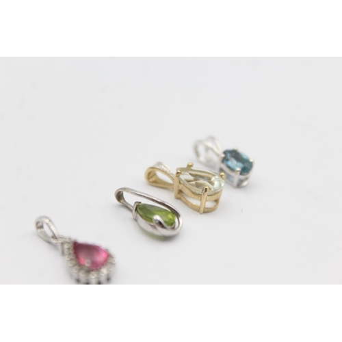 1057 - Four 9ct yellow and white gold gemstone set pendants, one peridot, one topaz, one coated pink topaz ... 