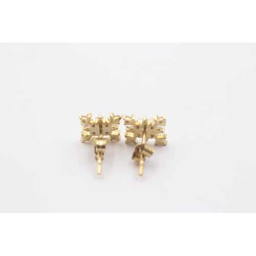 1068 - A pair of 9ct gold diamond snowflake cluster earrings - approx. gross weight 1.8 grams