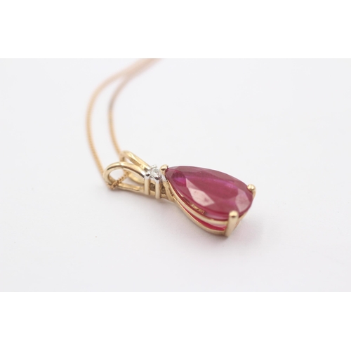 1069 - A 9ct gold glass filled ruby and diamond pendant necklace - approx. gross weight 3.1 grams