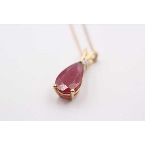 1069 - A 9ct gold glass filled ruby and diamond pendant necklace - approx. gross weight 3.1 grams