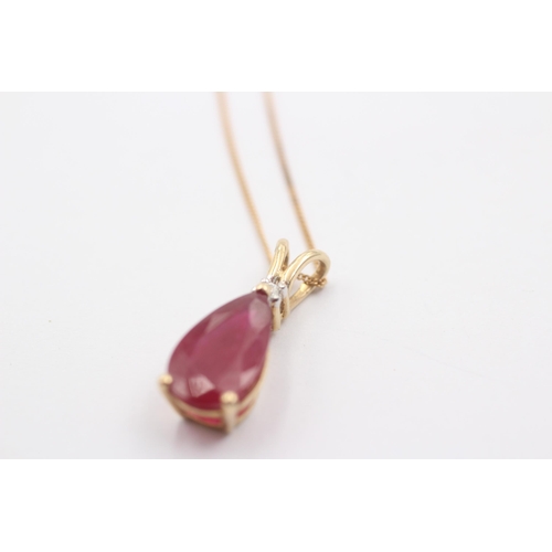 1069 - A 9ct gold glass filled ruby and diamond pendant necklace - approx. gross weight 3.1 grams