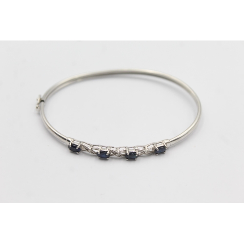 1094 - A 9ct white gold sapphire and diamond bangle - approx. gross weight 4.7 grams