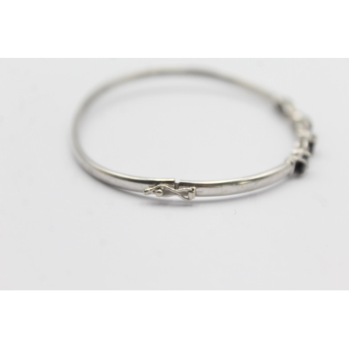 1094 - A 9ct white gold sapphire and diamond bangle - approx. gross weight 4.7 grams