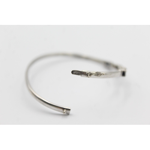 1094 - A 9ct white gold sapphire and diamond bangle - approx. gross weight 4.7 grams