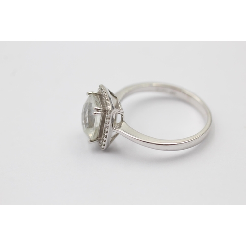 1111 - A 9ct white gold rock quartz and diamond halo dress ring - approx. gross weight 2.5 grams