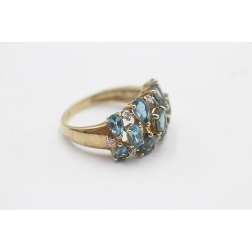 1123 - A 9ct gold blue topaz and diamond stylised cluster dress ring, size P½ - approx. gross weight 4.3 gr... 