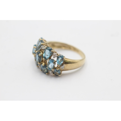 1123 - A 9ct gold blue topaz and diamond stylised cluster dress ring, size P½ - approx. gross weight 4.3 gr... 