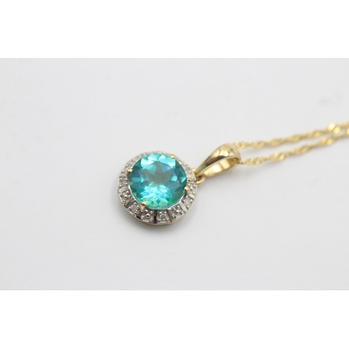 1129 - A 9ct gold coated blue topaz and diamond halo pendant necklace - approx. gross weight 1.4 grams