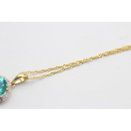 1129 - A 9ct gold coated blue topaz and diamond halo pendant necklace - approx. gross weight 1.4 grams