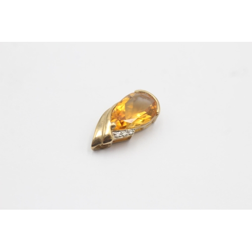 1141 - A 9ct gold diamond and citrine pendant - approx. gross weight 1.9 grams