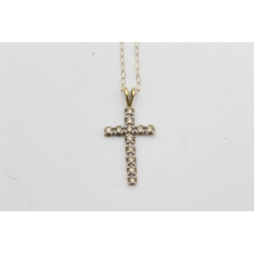 1143 - A 9ct gold diamond set cross pendant necklace - approx. gross weight 1.4 grams and 23cm long when fa... 