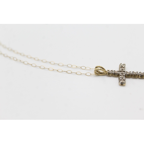 1143 - A 9ct gold diamond set cross pendant necklace - approx. gross weight 1.4 grams and 23cm long when fa... 