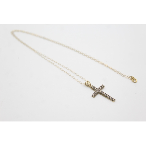 1143 - A 9ct gold diamond set cross pendant necklace - approx. gross weight 1.4 grams and 23cm long when fa... 