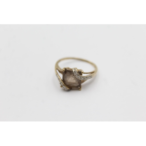 1145 - A 9ct gold smoky quartz and diamond stylised twist setting ring - approx. gross weight 2.3 grams