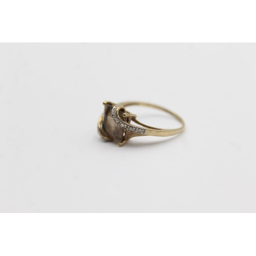 1145 - A 9ct gold smoky quartz and diamond stylised twist setting ring - approx. gross weight 2.3 grams