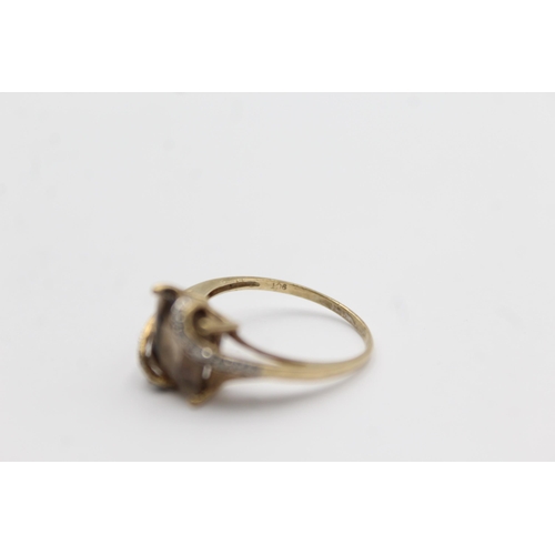 1145 - A 9ct gold smoky quartz and diamond stylised twist setting ring - approx. gross weight 2.3 grams