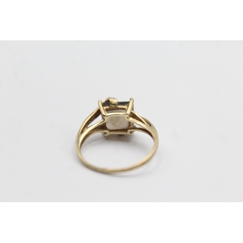 1145 - A 9ct gold smoky quartz and diamond stylised twist setting ring - approx. gross weight 2.3 grams