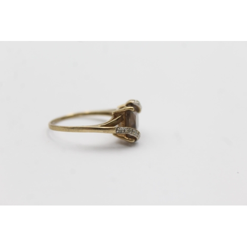 1145 - A 9ct gold smoky quartz and diamond stylised twist setting ring - approx. gross weight 2.3 grams