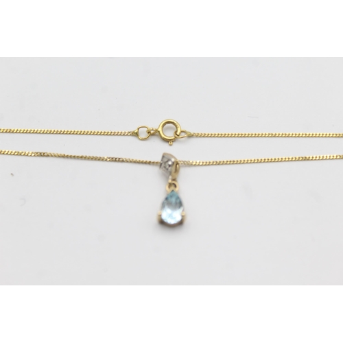 1149 - A 9ct gold blue topaz and diamond pendant necklace and earrings set - approx. gross weight 2.3 grams