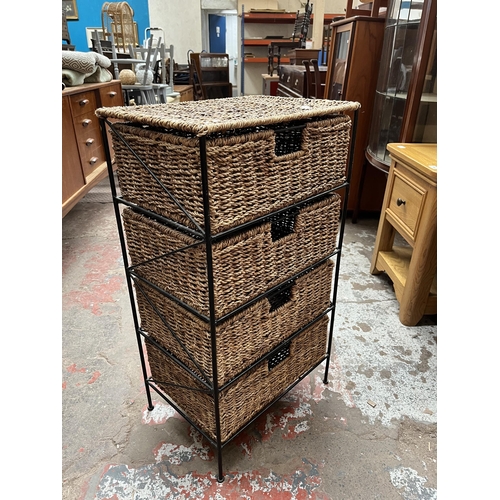 61 - A wicker and black metal chest of four drawers