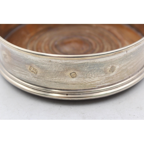 1275 - A hallmarked London silver and wooden bottle coaster