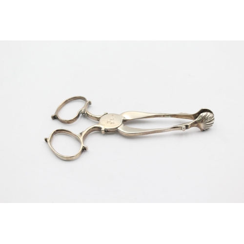 1303 - Two pairs of hallmarked silver sugar tongs - approx. gross weigh 55 grams