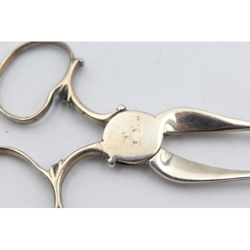 1303 - Two pairs of hallmarked silver sugar tongs - approx. gross weigh 55 grams