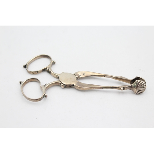 1303 - Two pairs of hallmarked silver sugar tongs - approx. gross weigh 55 grams