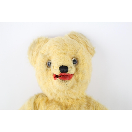 360 - A vintage jointed mohair teddy bear with glass eyes