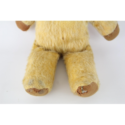 360 - A vintage jointed mohair teddy bear with glass eyes