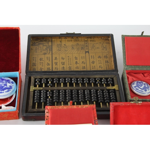 438 - A collection of Oriental desk accessories to include abacus etc.