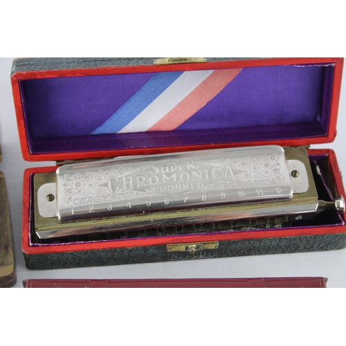 487 - Four vintage boxed M. Hohner harmonicas