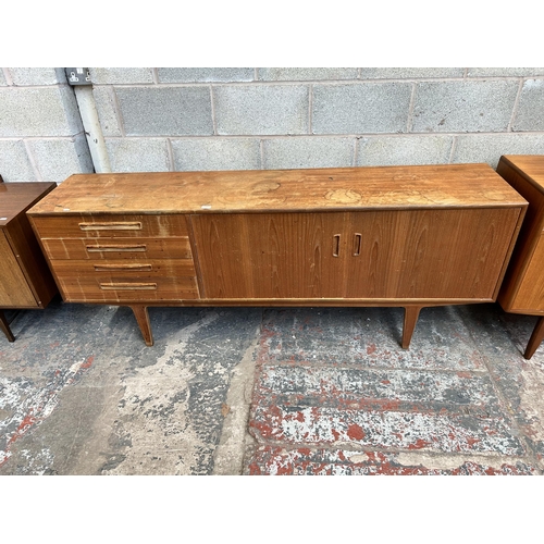 10 - A 1960s G Plan teak sideboard with four drawers and two cupboard doors