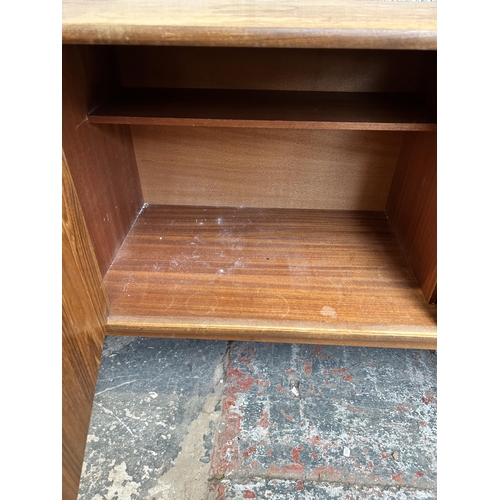 10 - A 1960s G Plan teak sideboard with four drawers and two cupboard doors